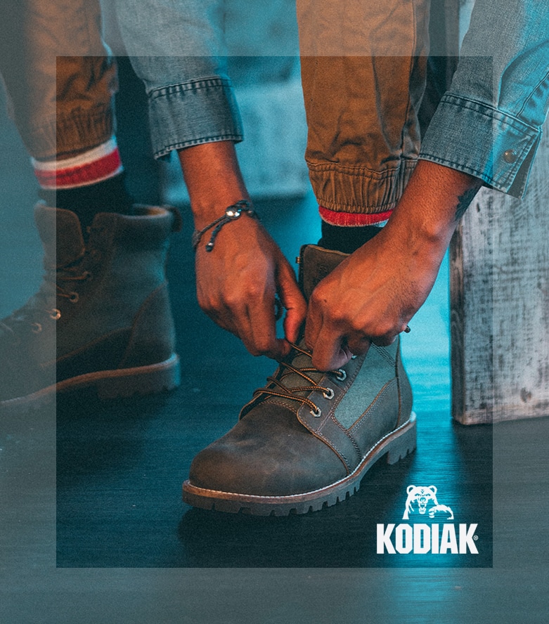 Kodiak - Man putting boots